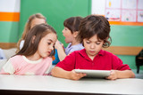 Children Using Digital Tablet At Preschool