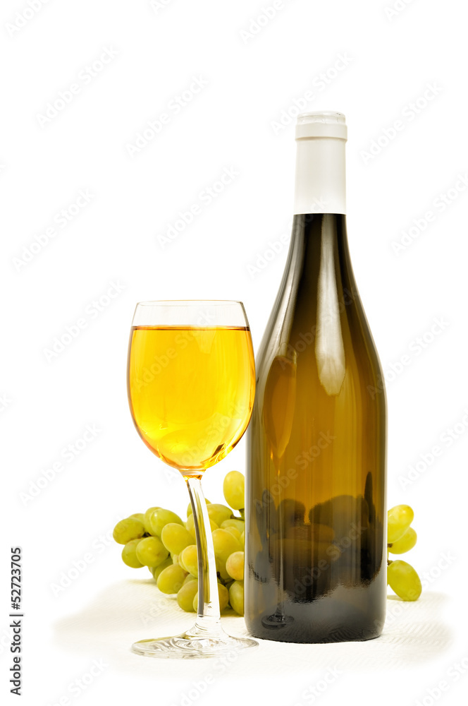 Glass with wine and bottle with green grapes