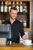 Barista Gesturing At Counter In Coffeeshop