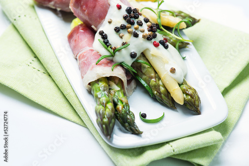 Green and white asparagus wrapped in prosciutto ham