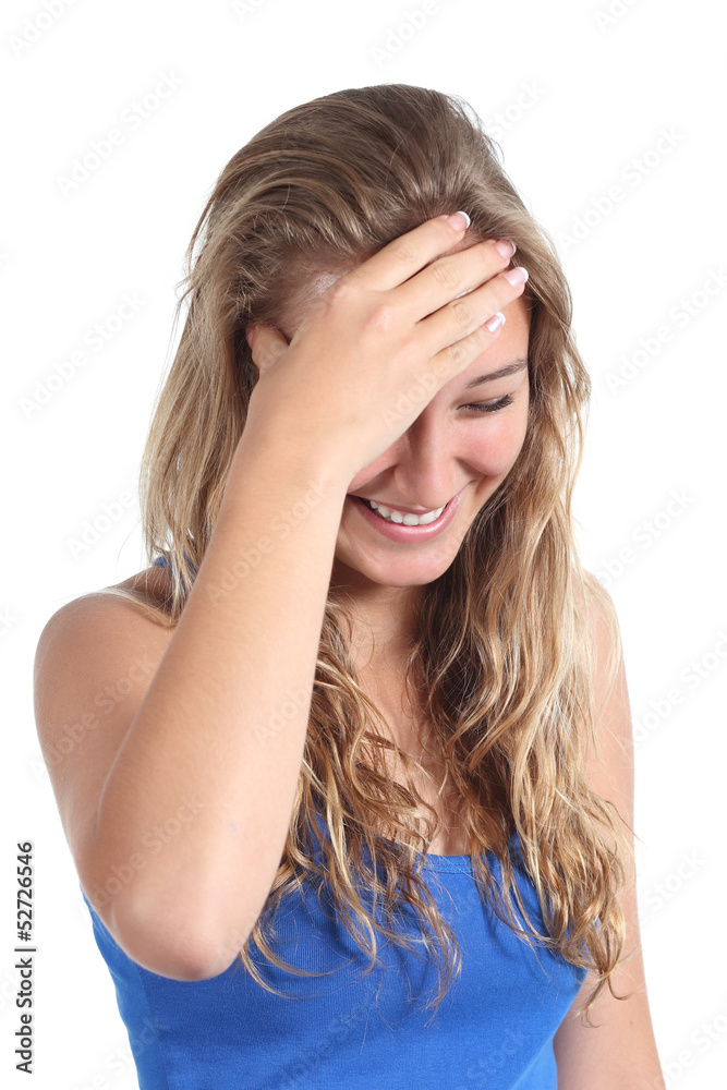 Happy teenager girl laughing with a hand in forehead Happy teenager girl laughing with a hand in forehead