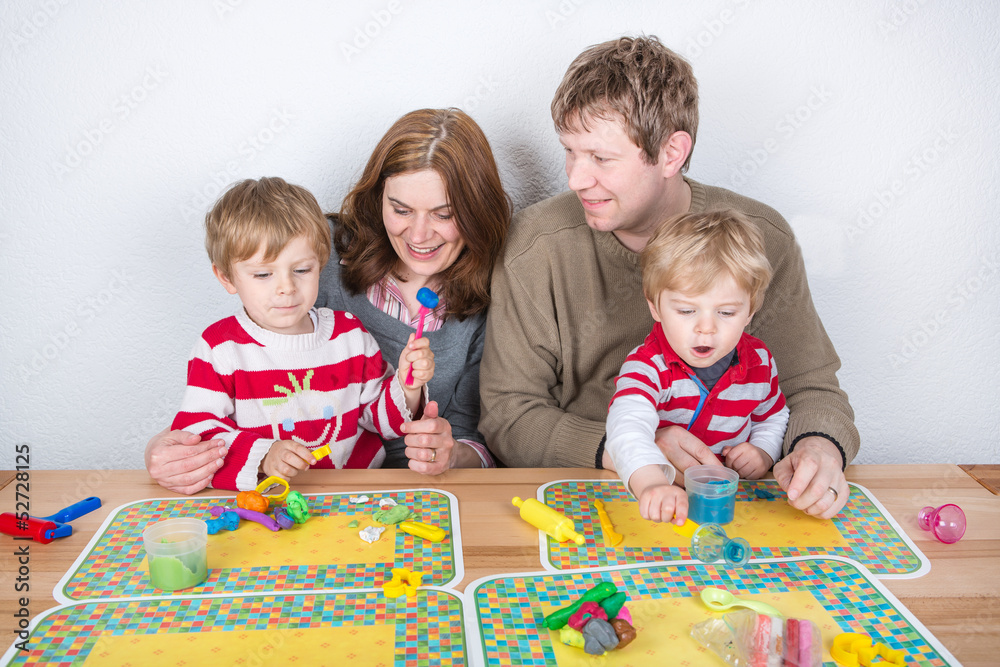 Fototapeta premium Happy family of a four having fun at home