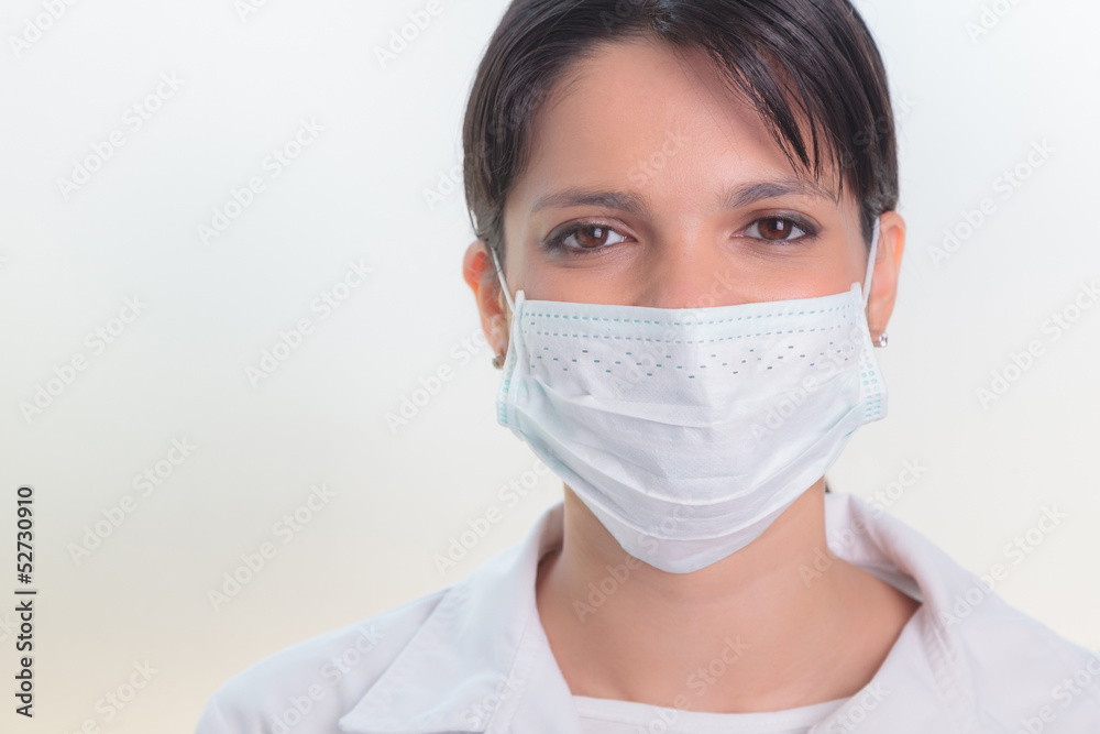 Close-up portrait of female doctor wearing mask