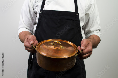 chef holding copper pan