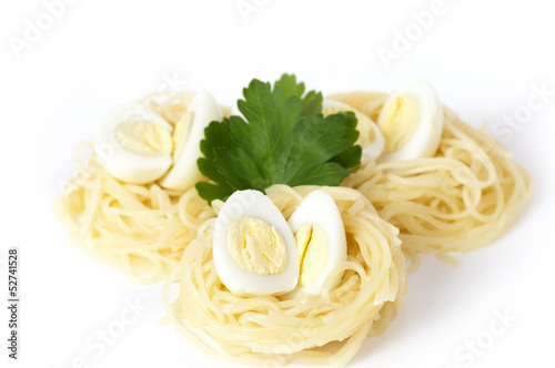 Nest pasta with quail eggs on white background