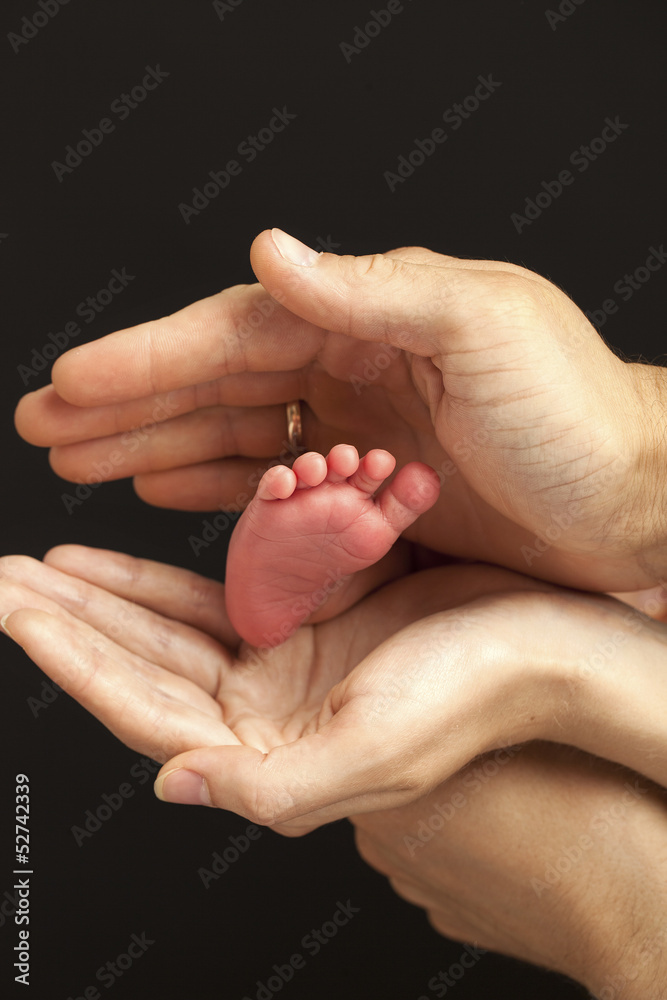 Newborn baby foot in parents hands Newborn baby foot in parents hands