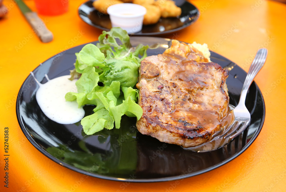 juicy grilled pork chop (neck cut) with greens juicy grilled pork chop (neck cut) with greens