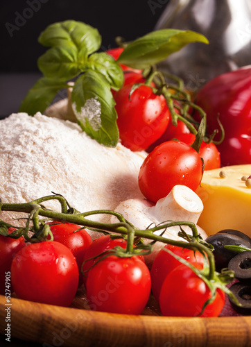 Ingredients for homemade pizza isolated in black