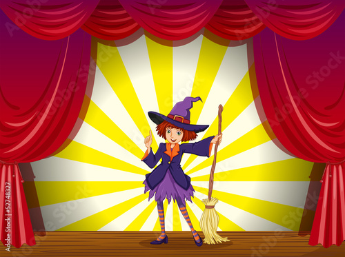 A witch at the stage with a red curtain