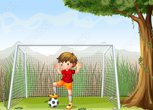 A young football player near the big tree