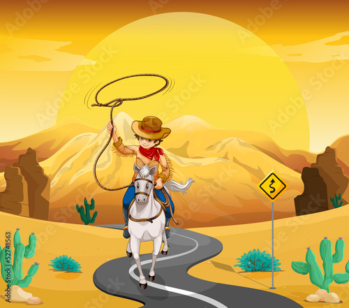 A cowboy riding on a horse travelling through the desert