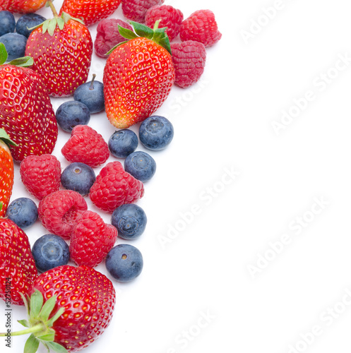 Background of assorted fresh berries isolated on white