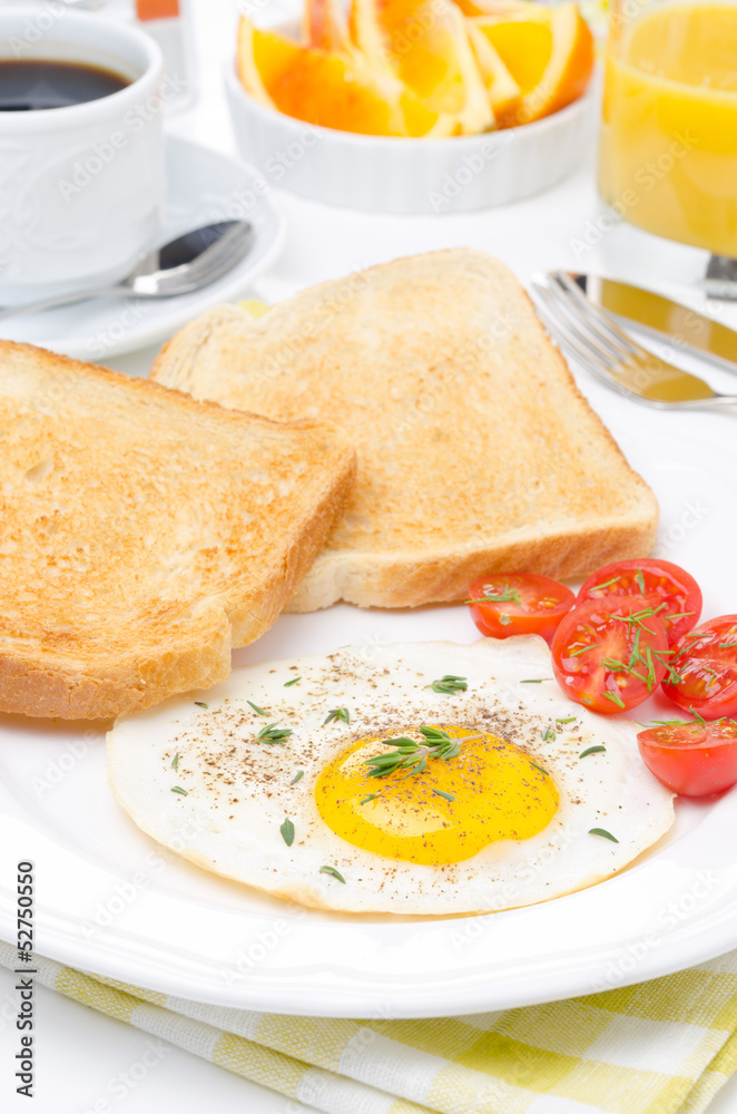 Fried eggs, fresh tomatoes and crunchy toast for breakfast