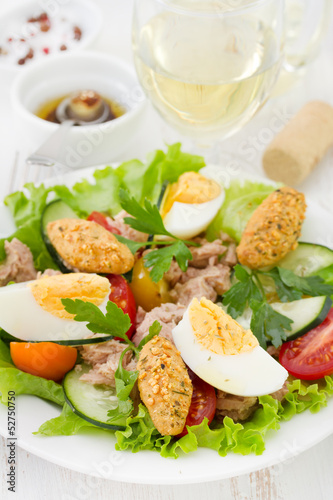 salad with fish and egg on the plate