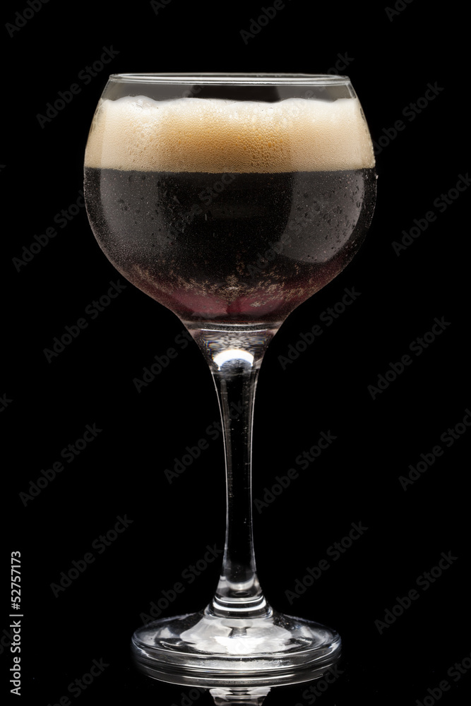Brown beer isolated on black