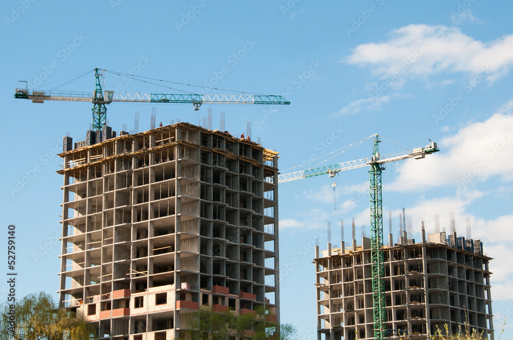 Construction of a high-rise building with a crane. Construction of a high-rise building with a crane.