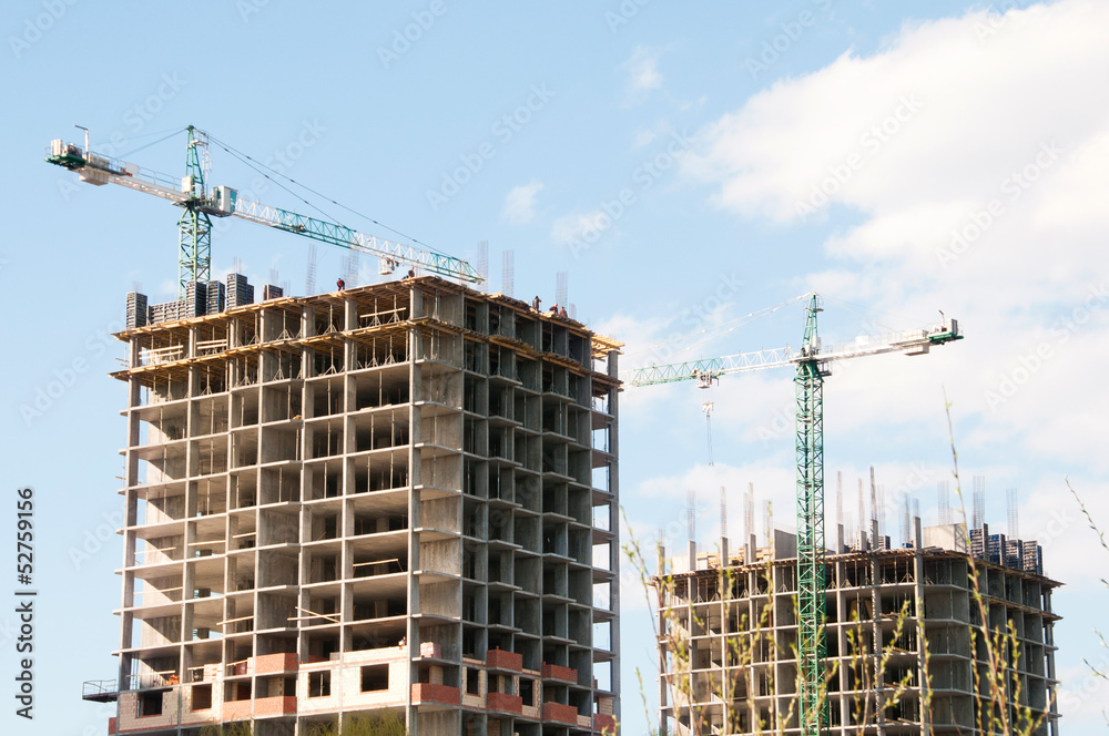 Construction of a high-rise building with a crane. Construction of a high-rise building with a crane.