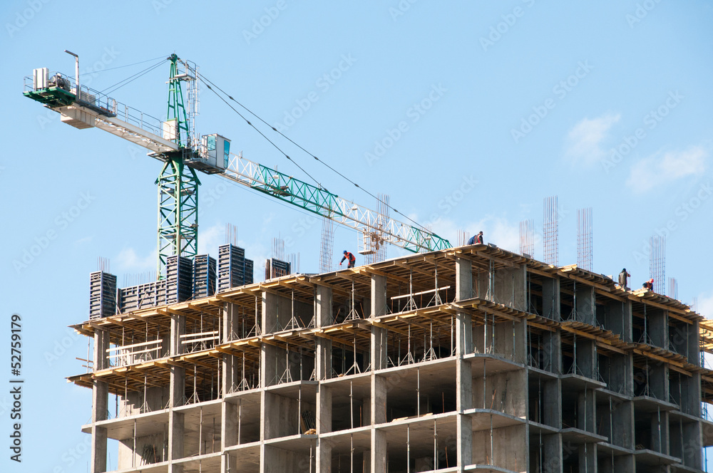 Construction of a high-rise building with a crane.