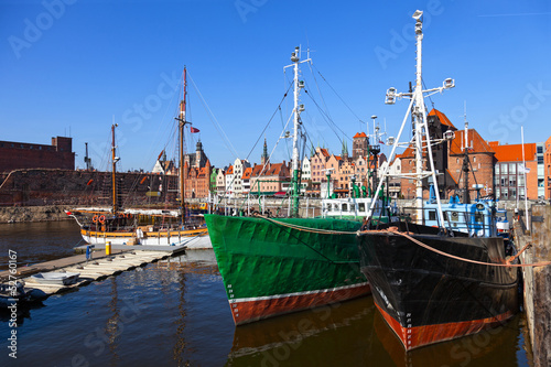 Old fishing boats on the background panorama of Gdansk, Poland.