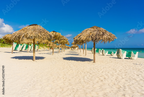 Umbrellas and beach beds on a beach in Cuba