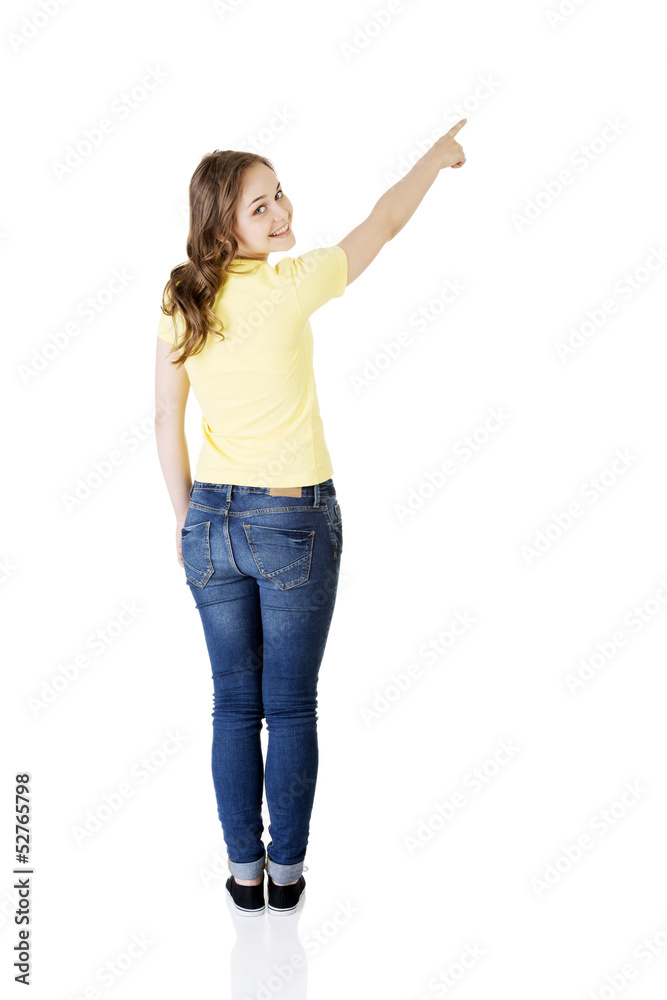Happy , excited young woman pointing on copy space Happy , excited young woman pointing on copy space