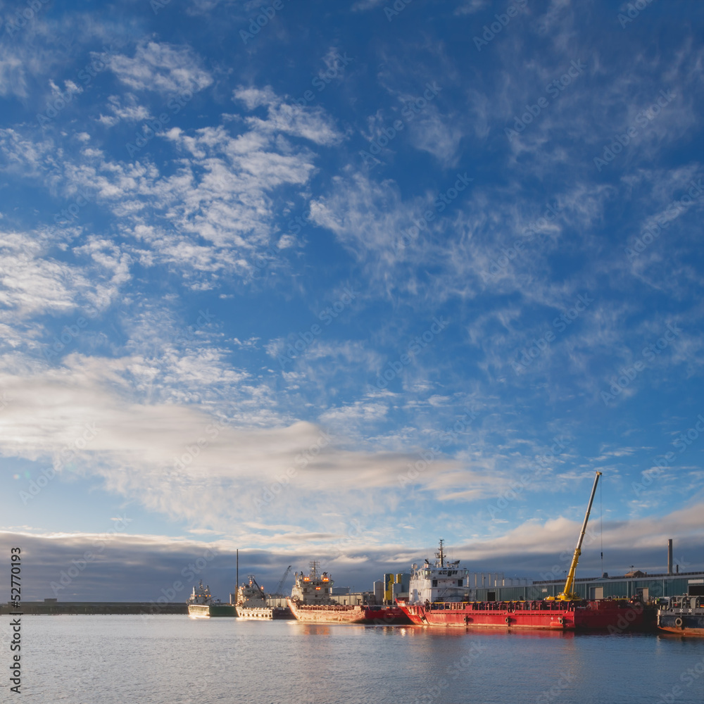 Oil platform supply vessels in a port during sunrise Oil platform supply vessels in a port during sunrise