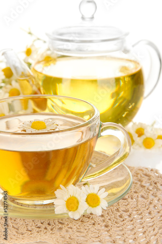 Cup of herbal tea with camomiles close up