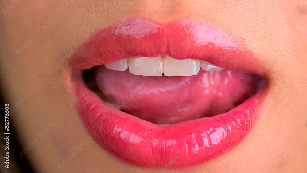 Extreme close up of licking lips and smiling
