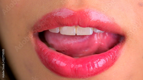 Extreme close up of licking lips and smiling