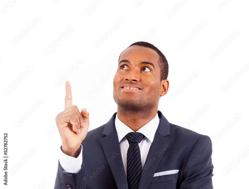 Portrait of happy African American businessman pointing upwards Portrait of happy African American businessman pointing upwards