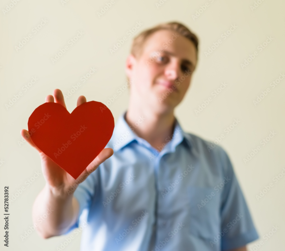 young guy holding a heart