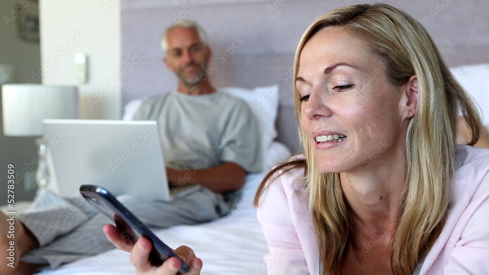 Woman hanging up the phone and talking to her husband Woman hanging up the phone and talking to her husband
