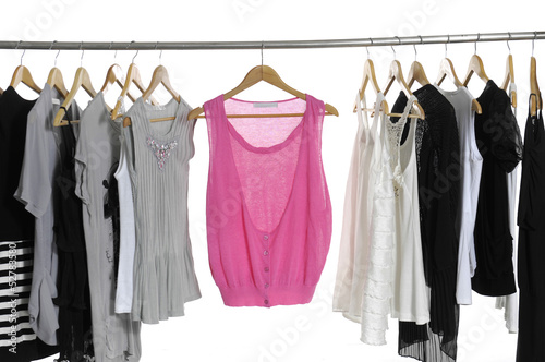 collection of women's clothes hanging on a rack.