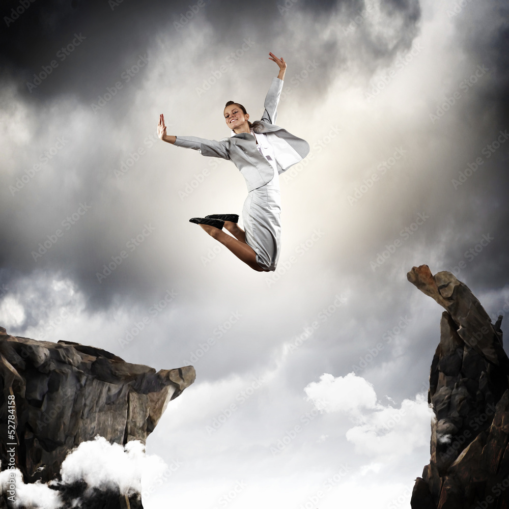 Young businesswoman jumping