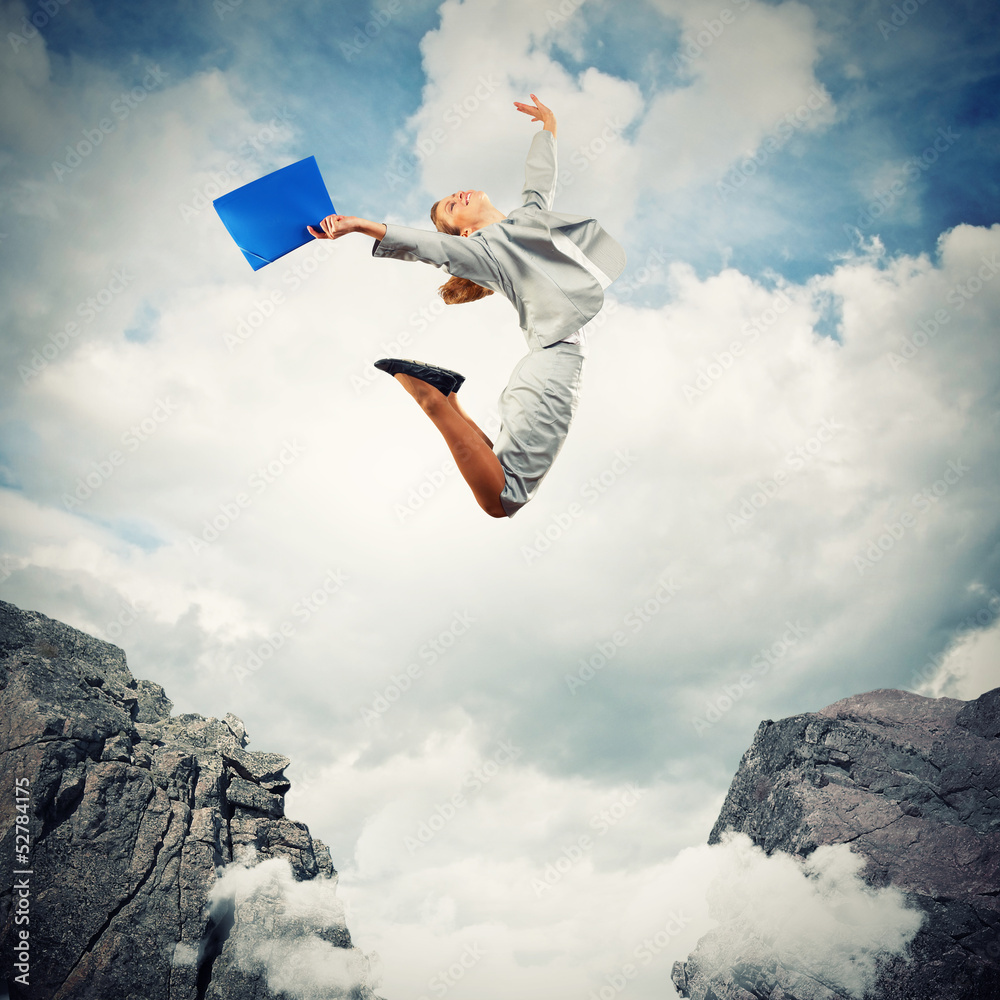 Young businesswoman jumping