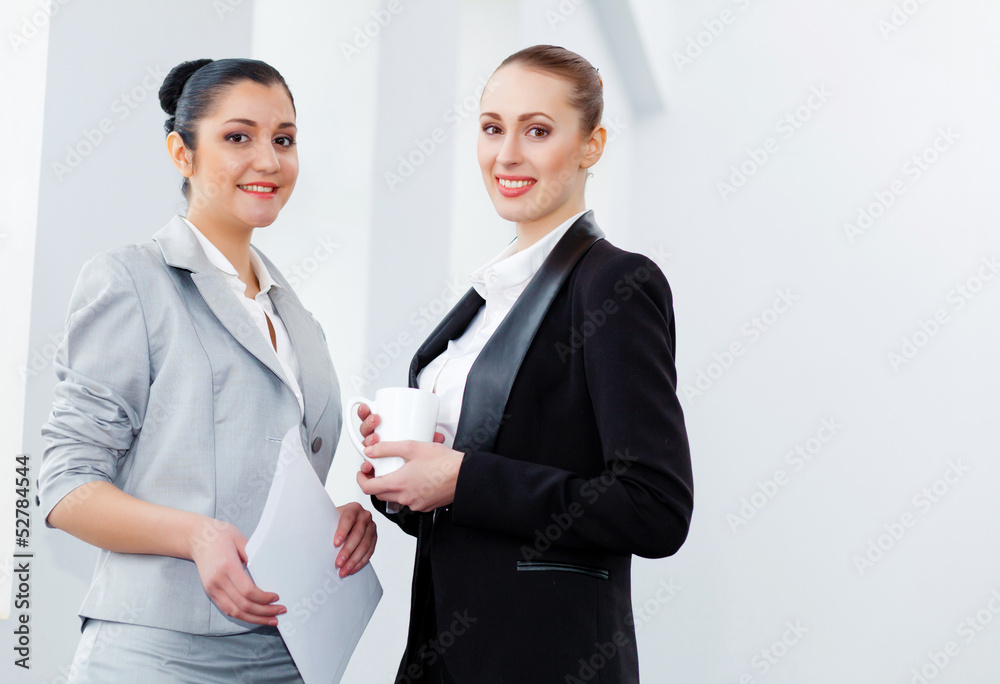 Two attractive business women smiling Two attractive business women smiling