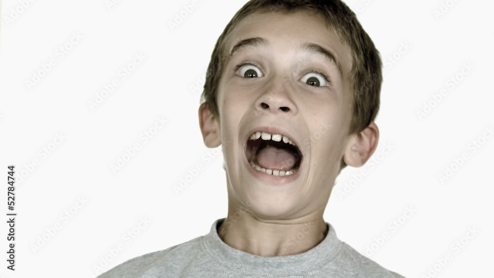 Boy grimacing against white background Boy grimacing against white background