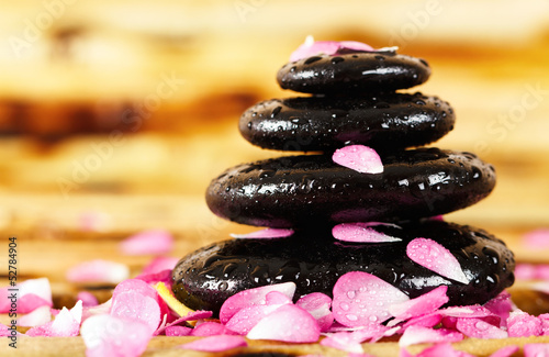 Spa stones with rose petals photo