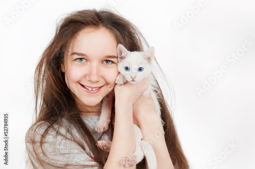 Portrait of a teenage girl with cat, on a gray background © Natalia Chircova