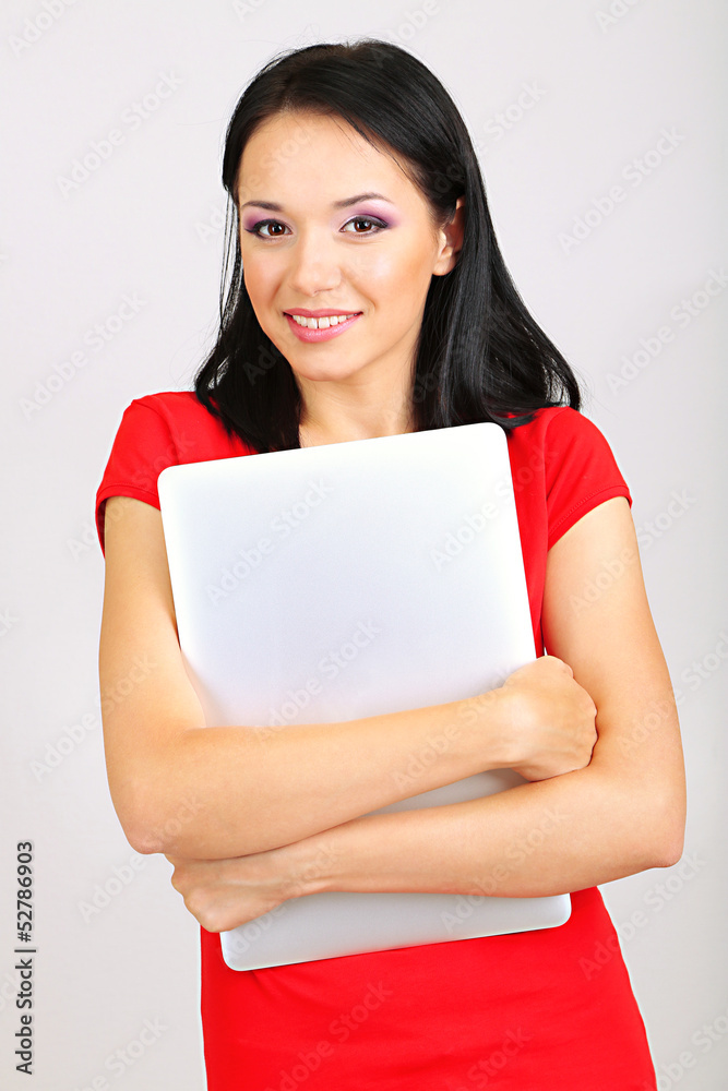 Beautiful young woman with notebook in room Beautiful young woman with notebook in room