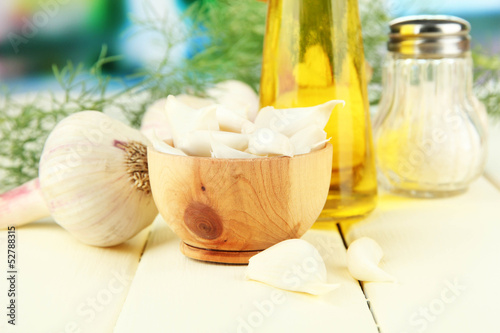 Fresh garlic on wooden table  on bright background