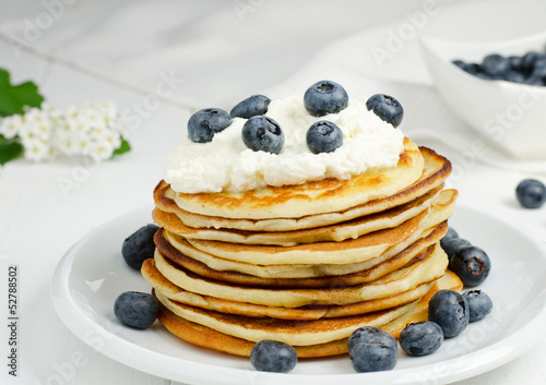 Small pancakes with cream and blueberries