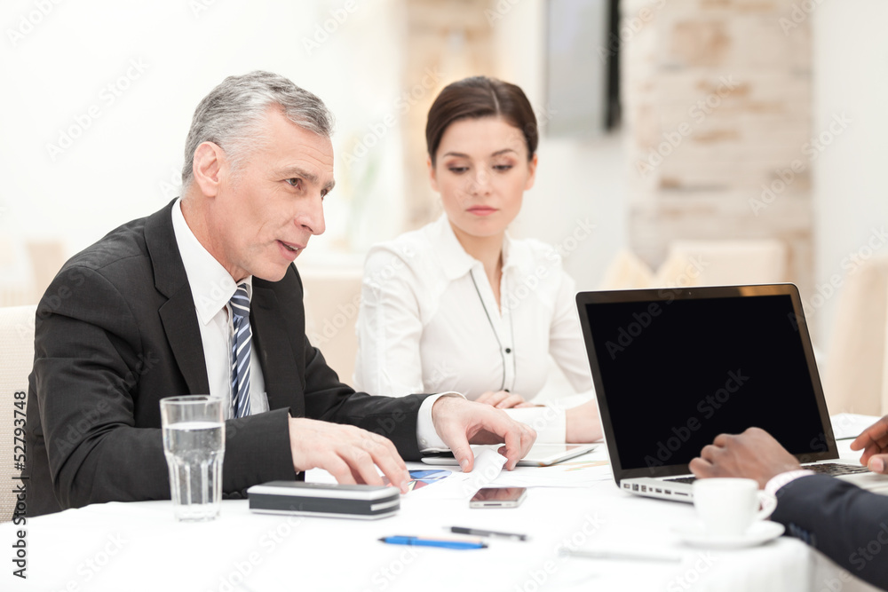 Senior businessman having staff meeting Senior businessman having staff meeting