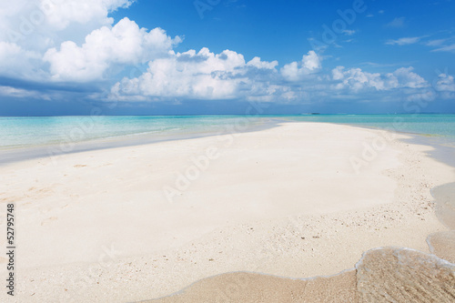 Fototapeta Naklejka Na Ścianę i Meble -  Seascape with white sand on the beach and blue sky with clouds