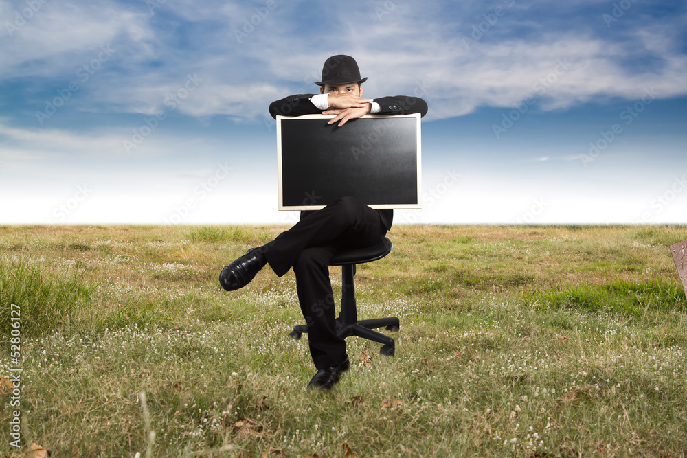 Businessman holding a blackboard. Businessman holding a blackboard.