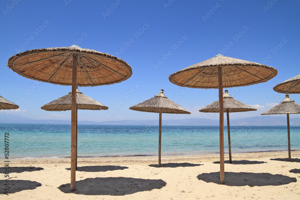 Straw umbrellas by the sea