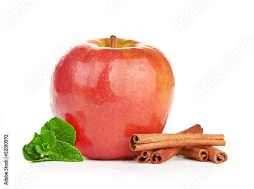 Red apple, cinnamon sticks and mint leaves