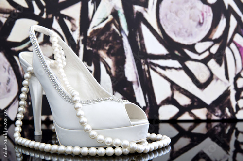 Wedding shoes with pearl necklace photo