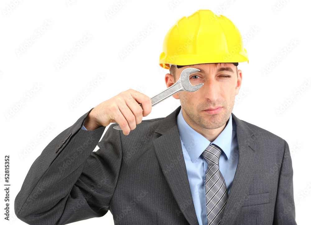 Young businessman in helmet with wrench isolated on white. Young businessman in helmet with wrench isolated on white.