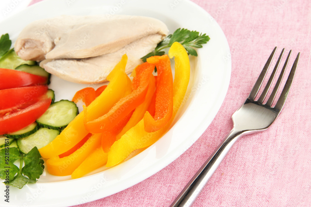 Boiled chicken breast on plate with vegetables close up Boiled chicken breast on plate with vegetables close up